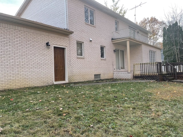 back of house with a yard and a deck