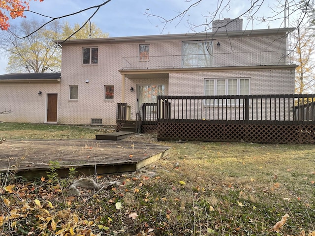 back of house featuring a yard and a deck