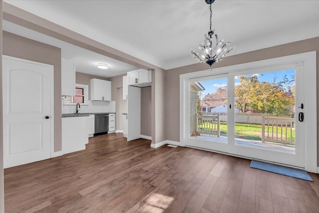 interior space with dark hardwood / wood-style flooring, a notable chandelier, and sink