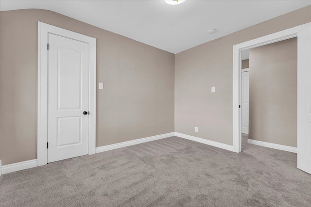 unfurnished room featuring light colored carpet