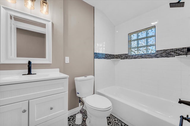 full bathroom featuring tiled shower / bath combo, tile patterned floors, lofted ceiling, toilet, and vanity