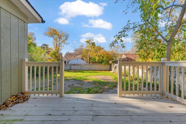 wooden terrace with a lawn