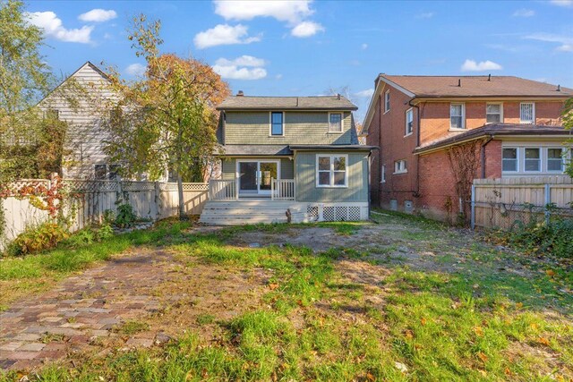 rear view of property with a wooden deck