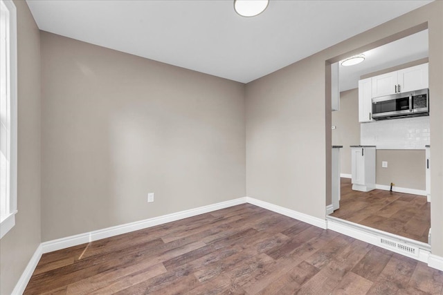 unfurnished room with hardwood / wood-style floors