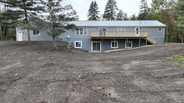 rear view of house with a wooden deck