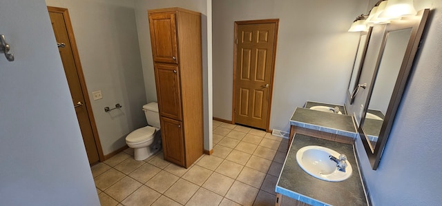 bathroom with tile patterned floors, vanity, and toilet