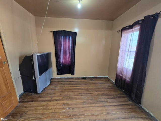 empty room featuring dark wood-type flooring