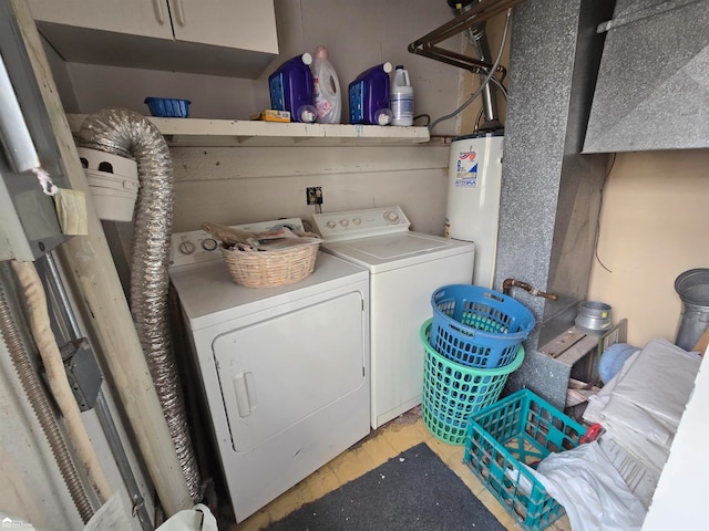 washroom featuring cabinets, water heater, and washing machine and clothes dryer