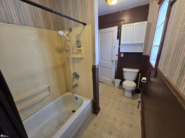 182 W Vienna St, Clio, MI 48420 - full bathroom featuring tile patterned floors, toilet, wallpapered walls, and tub / shower combination