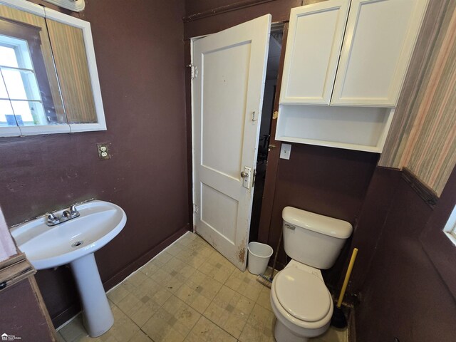 182 W Vienna St, Clio, MI 48420 - bathroom with toilet, tile patterned floors, and baseboards
