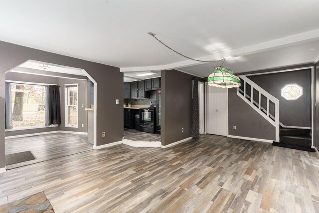 unfurnished living room with hardwood / wood-style flooring