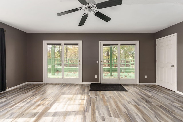 doorway to outside with light hardwood / wood-style floors, plenty of natural light, and ceiling fan