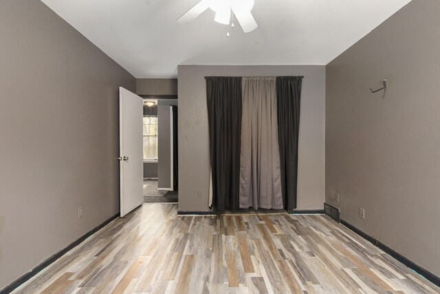 unfurnished room featuring ceiling fan and light hardwood / wood-style flooring