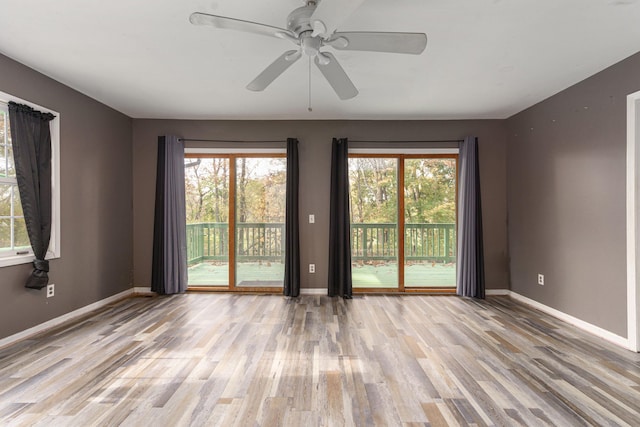 spare room with light wood-type flooring and ceiling fan