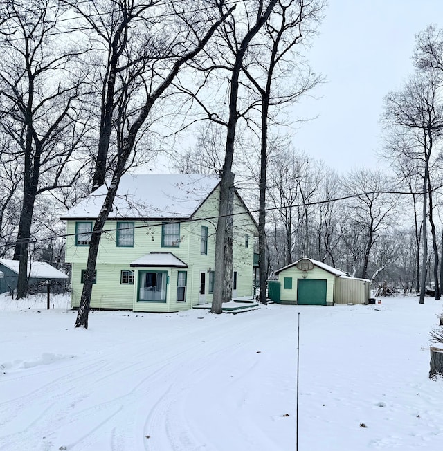 view of front facade with a garage and an outbuilding