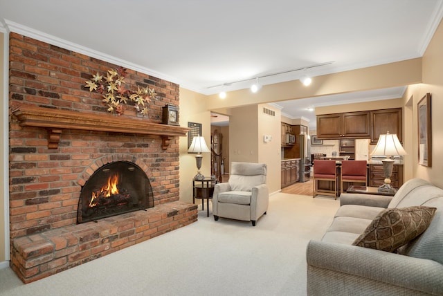 carpeted living room featuring a fireplace, track lighting, and crown molding