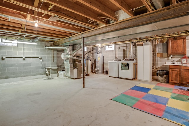 basement featuring heating unit, electric panel, washer and clothes dryer, and water heater