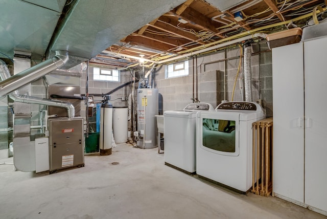 basement featuring gas water heater and washing machine and clothes dryer