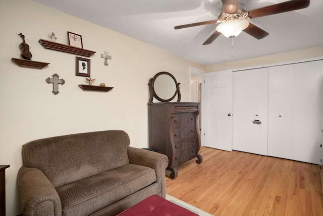 sitting room with ceiling fan and light hardwood / wood-style flooring