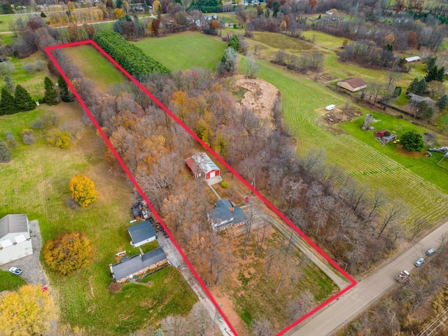 birds eye view of property with a rural view