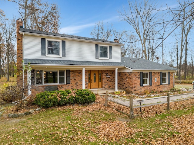 front facade with a front lawn and a porch