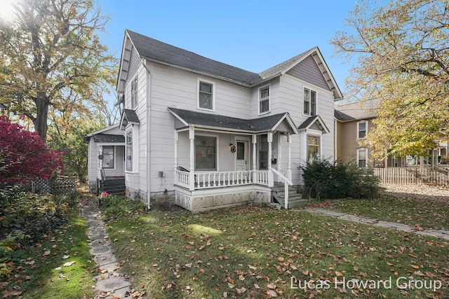 view of property with a front lawn and a porch