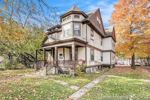 victorian house with a porch and a front yard