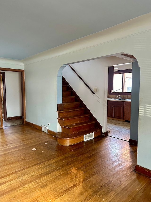 unfurnished room featuring light wood-type flooring and sink