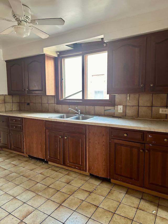 kitchen featuring backsplash, ceiling fan, and sink