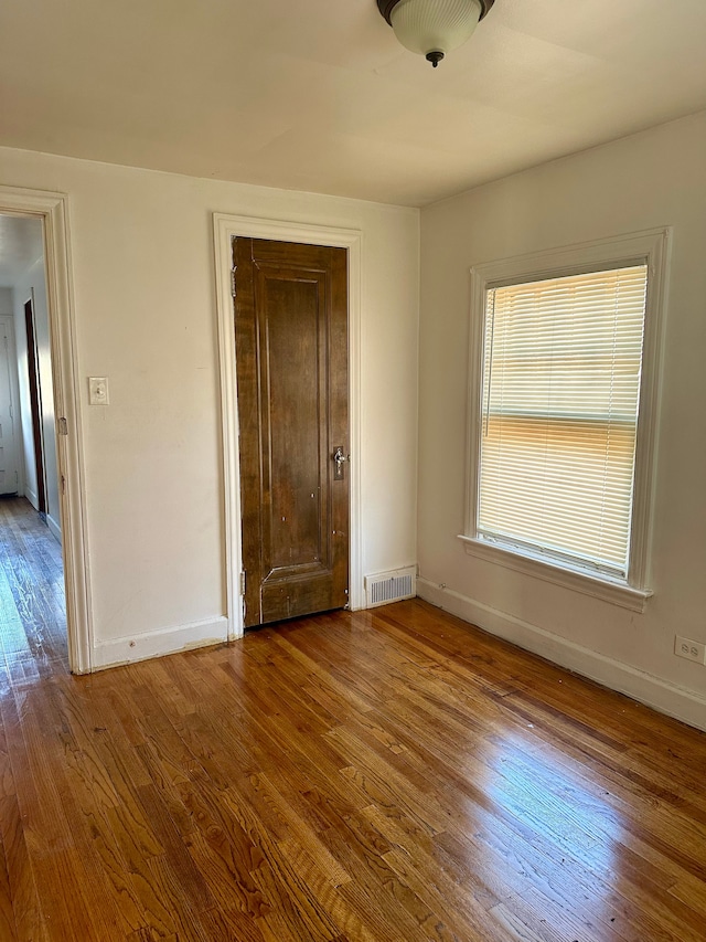 unfurnished bedroom with hardwood / wood-style floors