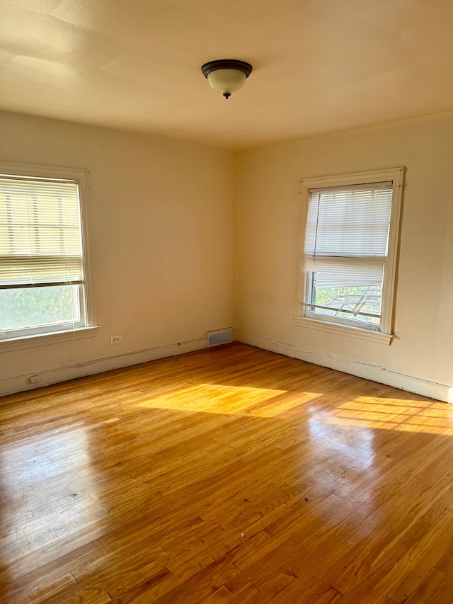 unfurnished room with light wood-type flooring