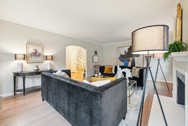 living room featuring light hardwood / wood-style flooring and ornamental molding