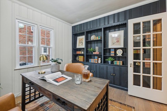 office area featuring hardwood / wood-style floors and crown molding