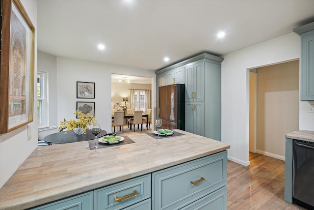 kitchen featuring stainless steel fridge, light wood-type flooring, and a healthy amount of sunlight