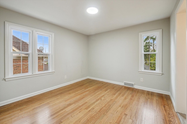 spare room featuring light wood-type flooring