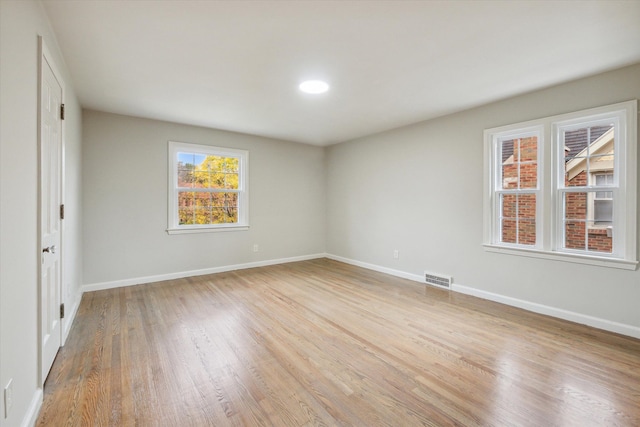 spare room featuring light wood-type flooring