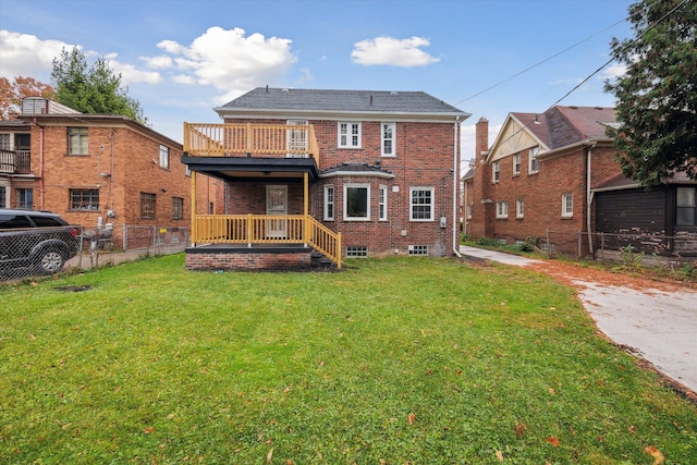 back of property with a lawn and a balcony