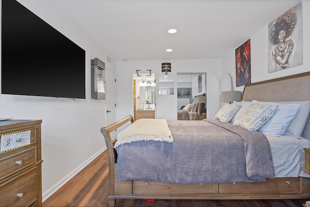 bedroom with hardwood / wood-style floors and a closet