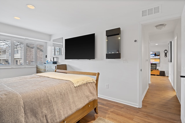 bedroom with light hardwood / wood-style floors