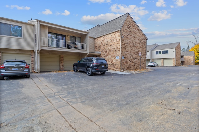 view of front facade with a garage and a balcony