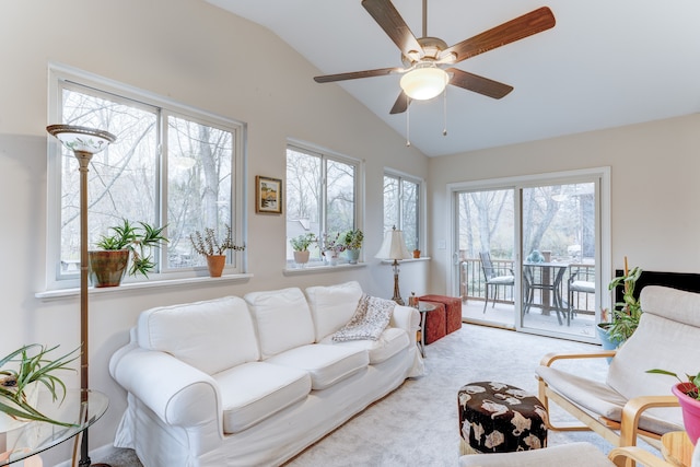 carpeted living room featuring plenty of natural light, ceiling fan, and vaulted ceiling