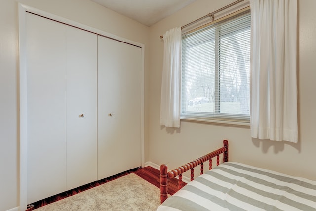 bedroom featuring hardwood / wood-style floors and a closet