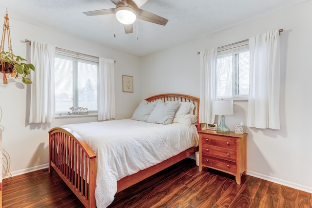 bedroom with ceiling fan and dark hardwood / wood-style flooring