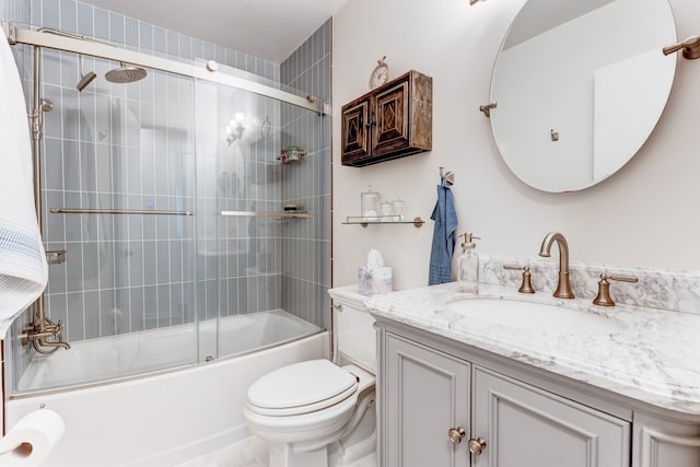 full bathroom featuring vanity, bath / shower combo with glass door, and toilet