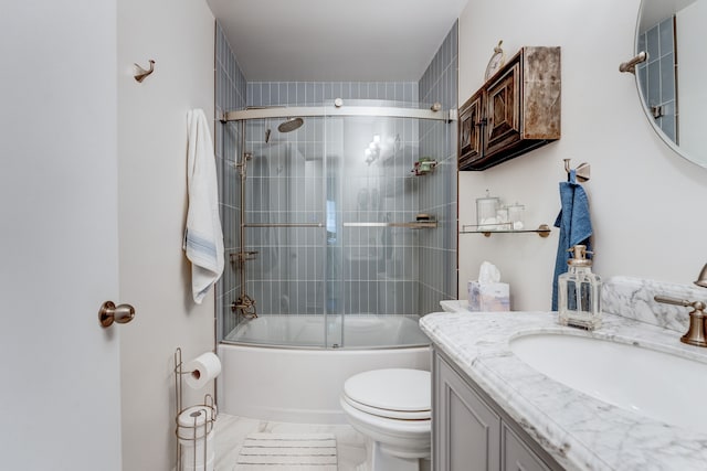 full bathroom with toilet, vanity, and bath / shower combo with glass door