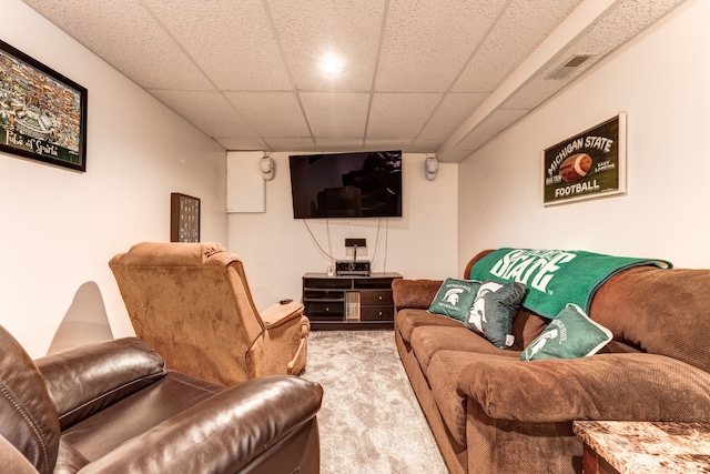 carpeted living room featuring a paneled ceiling