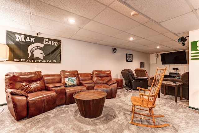 home theater room featuring a drop ceiling and carpet floors