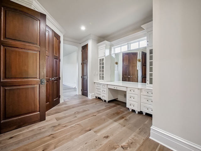 bathroom with vanity, hardwood / wood-style flooring, and ornamental molding