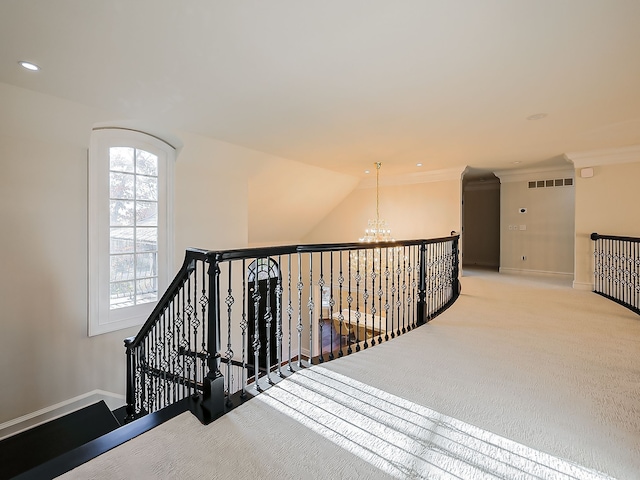 stairway featuring carpet, a notable chandelier, and ornamental molding