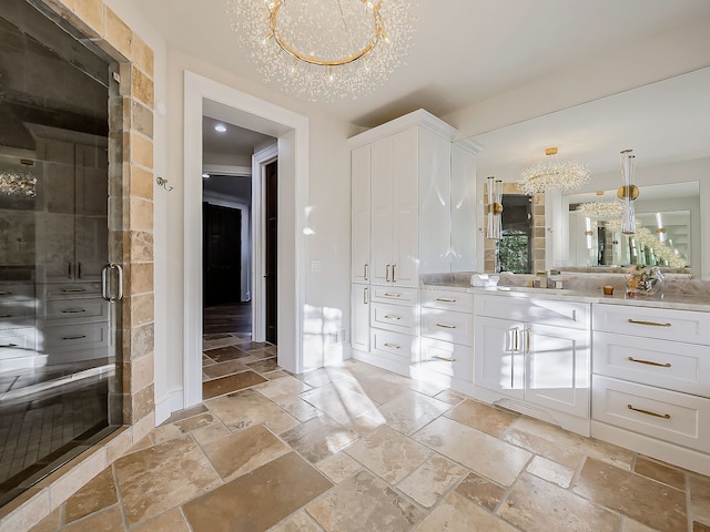 bathroom featuring a textured ceiling, vanity, walk in shower, and a notable chandelier